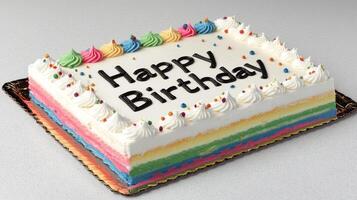This vibrant cake features layers of color topped with cheerful frosting and festive text photo