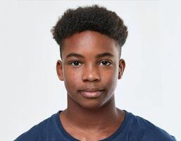 Close Up Portrait of African Teenager with Defined Defined Defined Defined Soft Curly Texture on White Background photo