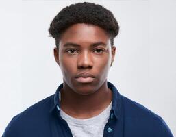 Portrait of African Teenager with Defined Defined Defined Defined Short Curly Curls and Expression on White Background photo