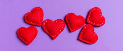 Composition of textile red hearts on colorful background empty space for your design. Top view of St. Valentine's day concept photo