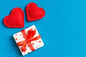 Top view of gift boxes and red textile hearts background. day concept with copy space photo