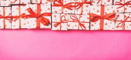 Holiday composition of gift boxes with hearts on colorful background with empty space for your design. Top view of Valentine's Day concept photo