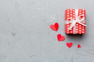 Valentine day composition red gift box with bow. Christmas present. View from above. Space for text. Holday greeting card photo