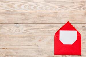 Red paper envelope empty white card. top view valentines day concept photo