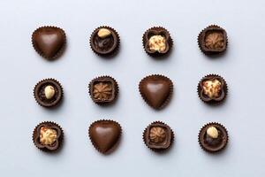 Different kinds of chocolates on colored table and Flat Lay photo