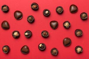Different kinds of chocolates colored table close-up. Top Flat Lay photo