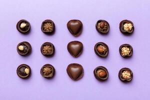 Different kinds of chocolates colored table close. Top View Flat Lay photo