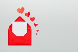 Red paper envelope with empty white card and heart photo