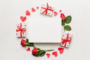 Frame made of rose, git box, heart and blank greeting mockup Colored background. Top view, flat lay, copy space Holiday, Mothers Day, birthday concept photo