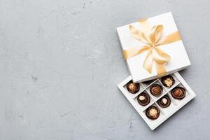 White box with chocolates candies and tape. top view with copy space photo