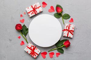 Frame made of rose, git box, heart and blank greeting mockup on Colored background. Top view, flat lay, copy space Holiday, Mothers Day, birthday concept photo