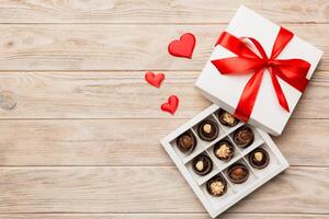 Delicious chocolate in red box for Valentine's Day. shaped box of chocolates top view with copy space photo