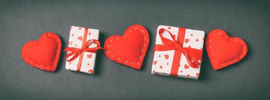 Holiday of gift boxes red textile hearts on colorful background with empty space for your design. Top view of Valentine's Day concept photo