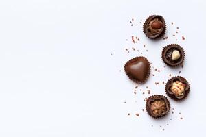 Different kinds of chocolates on colored table closeup. Top View and Flat Lay with copy space photo