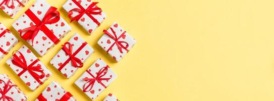 Top view gift boxes with red hearts on colorful background. St Valentine's day concept with copy space photo