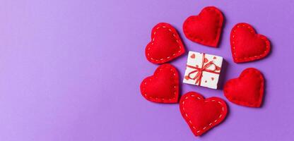 Holiday composition gift boxes and red textile hearts on colorful background with empty space for your design. Top view of Valentine's Day concept photo