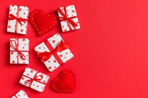 Top view of gift boxes and red textile hearts colorful background. St Valentine's day concept with copy space photo