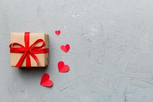 Valentine day composition red gift box with bow heart. Christmas present. View from above. Space for text. Holday greeting card photo