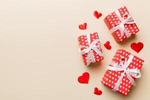 Valentine day composition red gift with bow and heart. Christmas present. View from above. Space for text. Holday greeting card photo