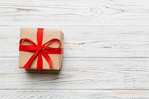 Valentine day red gift box with bow and heart. present. View from above. Space for text. Holday greeting card photo