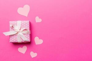 Valentine day composition gift box with bow and heart. Christmas present. View from above. Space for text. Holday greeting card photo