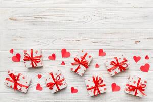Valentine day composition red gift box bow and heart. Christmas present. View from above. Space for text. Holday greeting card photo