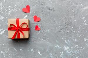 Valentine day red gift box with bow and heart Christmas . View from above. Space for text. Holday greeting card photo