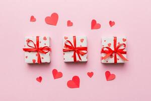 Valentine day red gift box with bow and heart. View from above. Space for text. Holday greeting card photo