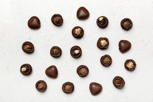 Different kinds of chocolates on table close-up. Top View and Flat Lay photo