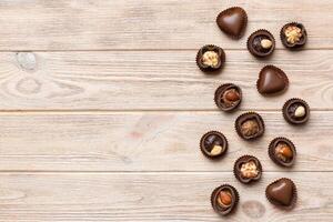 Different kinds of chocolates on colored table close up. Top View and Flat Lay with copy space photo