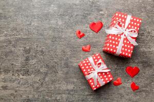 Valentine day composition red gift box with bow heart Christmas present. View from above. Space for text. Holday greeting card photo