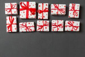 Top view of gift boxes with red hearts colorful background. St Valentine's day concept with copy space photo