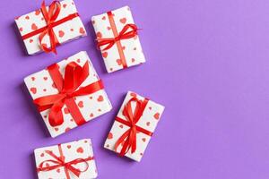 Top view colorful valentine background made gift boxes with red hearts. Valentine's Day concept with copy space photo