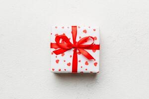 Valentine day composition gift box with bow and heart. present. View from above. Space for text. Holday greeting card photo
