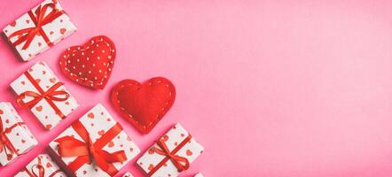 Top view of gift boxes red textile hearts on colorful background. St Valentine's day concept with copy space photo