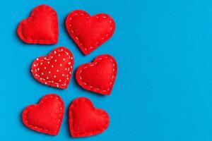 Composition textile red hearts on colorful background with empty space for your design. Top view of St. Valentine's day concept photo