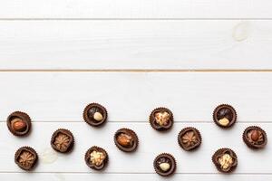 Different kinds of chocolates colored table close-up. Top View and Flat Lay photo
