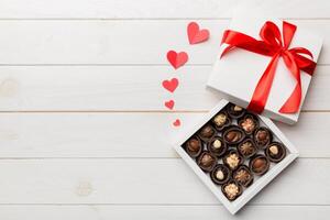 Delicious chocolate pralines in red box for Valentine Day. box of chocolates top view with copy space photo
