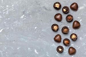 Different of chocolates on colored table close-up. Top View and Flat Lay with copy space photo