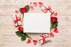 Frame made rose, git box, heart and blank greeting card mockup on Colored background. Top view, flat lay, copy space Holiday, Mothers Day, birthday concept photo