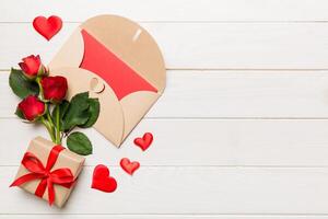 Valentine day composition with envelope, rose flower and on table. Top view, flat lay, copy space Holiday concept photo