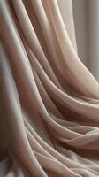 A close-up of flowing vertical fabric in soft shades, creating blank areas that are perfect for text or graphic overlays. photo