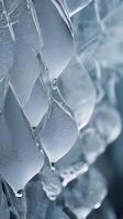 Vertical composition of intricate frost patterns on a surface, offering a tranquil and understated aesthetic. photo
