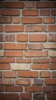 A high-resolution vertical view of a rustic brick wall with faded hues and plenty of open space for text placement photo