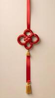 A refined design featuring a golden Chinese knot with a red ribbon on a smooth light background, offering open space for text placement. photo