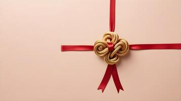 A serene design featuring a golden Chinese knot with a red ribbon on a soft, neutral-colored backdrop, leaving open space for a message. photo