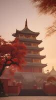 A calm, peaceful Chinese temple silhouette with a soft gradient sky of red and gold, providing space for text at the front. photo