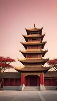 A tranquil Chinese temple silhouette against a gradient sky with soft red and gold tones, offering space for text placement in the foreground. photo