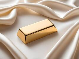 A gold ingot sits gracefully on a white silk background, enveloped in soft light, creating a peaceful ambiance with room for text. photo