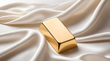 A delicate gold ingot is positioned on a white silk background, softly illuminated, offering a calm atmosphere and room for text. photo